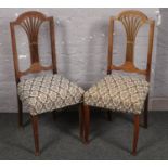 A pair of oak upholstered chairs.