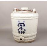 A mid 20th century Japanese blue and white sake barrel. Painted with wide brush strokes in