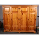 A large modern pine quadruple wardrobe of 'knock-down' construction, 240cm x 200cm.