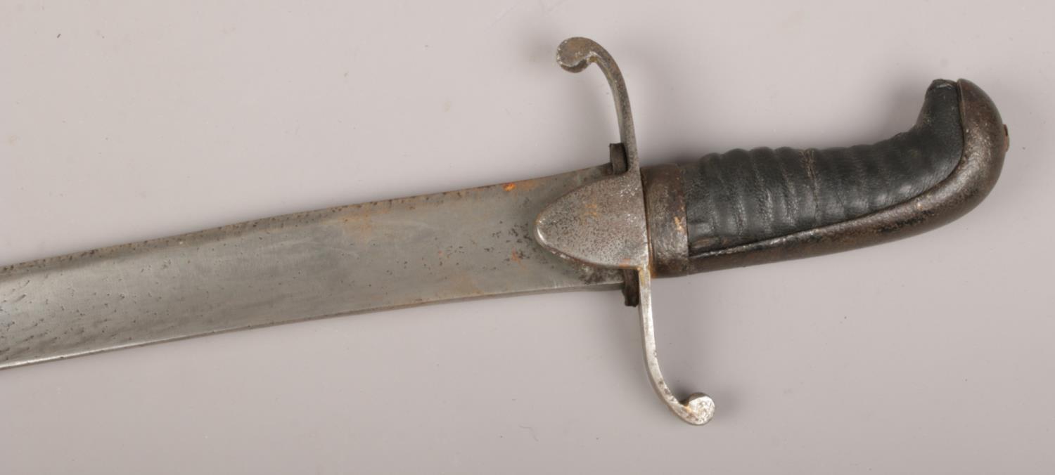 An early 19th century British sabre with scrolling cross guard and leather mounted grip. Blade 73cm. - Image 3 of 3