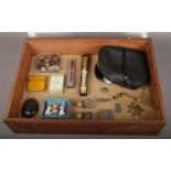 A bijouterie case of collectables, to include coins, cap with constable badge, pen knives etc.