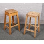 A pair of vintage hardwood school science laboratory stools.