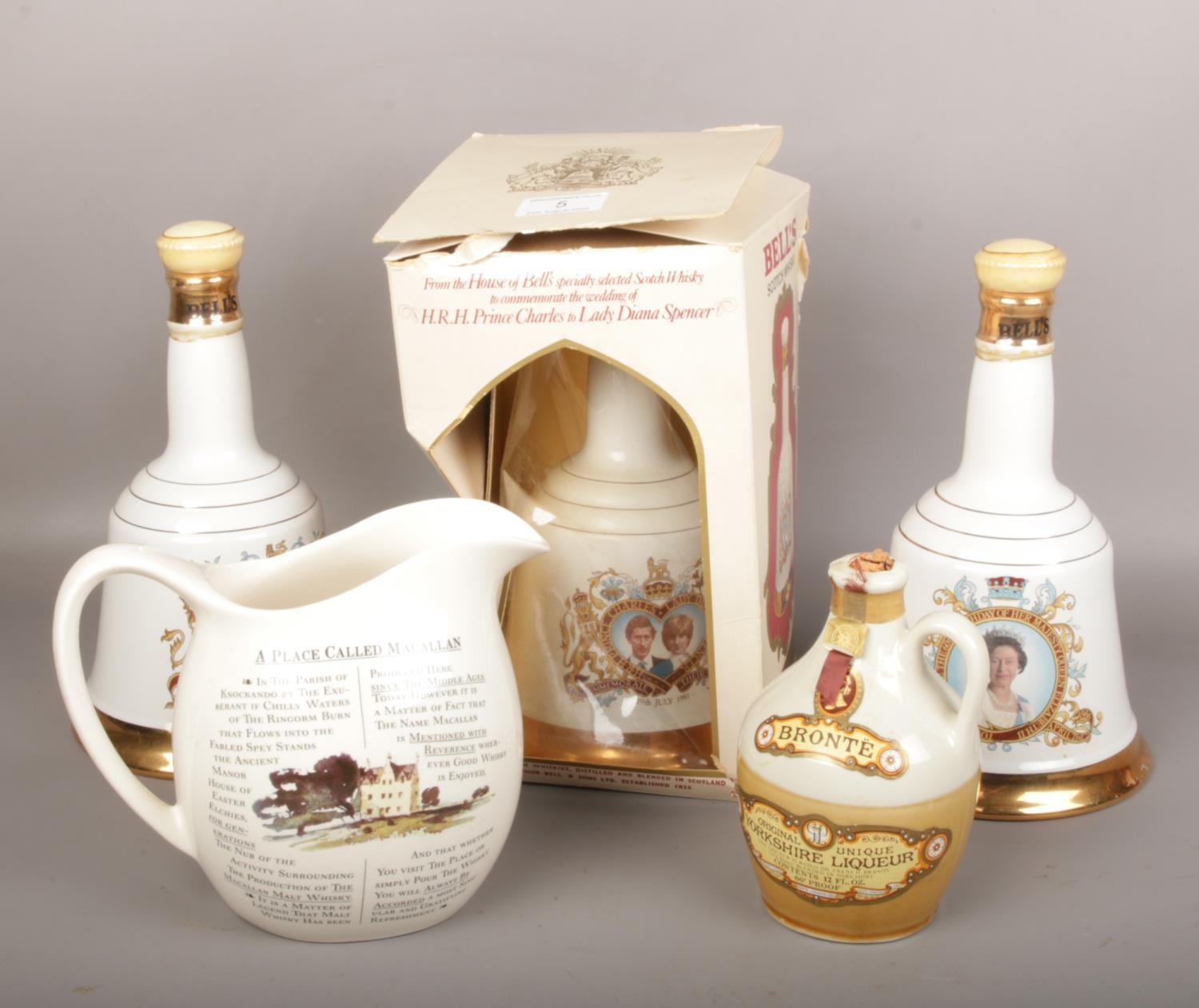 Three Wade Bells whisky decanters, full and sealed, one boxed. A flagon of full and sealed Yorkshire