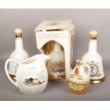 Three Wade Bells whisky decanters, full and sealed, one boxed. A flagon of full and sealed Yorkshire