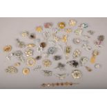 A quantity of vintage costume jewellery brooches including white and coloured past examples.