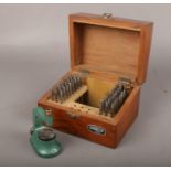 A wooden cased set of Dracip watch maker's tools.