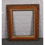 An early 20th century oak and gilt picture frame. (Interior measurements 50cm x 40cm).