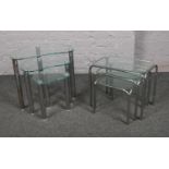 Two sets of chrome effect and glass nest of three tables.