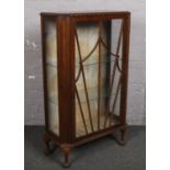 A mahogany astrigal glazed display cabinet, raised on ball and claw feet.