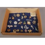 A box of costume jewellery, assorted brooches