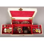 A cantilever jewellery box containing vintage and antique costume jewellery. Including cameo