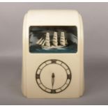 A cream Bakelite Art Deco electric clock with ship automaton by Vitascope Industries, 32cm high. Not