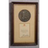 A World War I bronze death plaque and Buckingham Palace letter framed as one to Harry Walker.