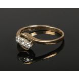 A 9ct gold three stone diamond ring. (1.87g) (Size M).