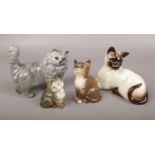 Four Beswick ceramic figures of cats. Good condition.