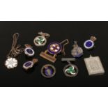 A collection of silver and silver gilt badges and awards, including enameled examples and a St