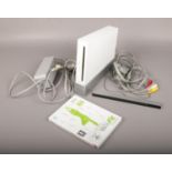 A Nintendo Wii console, along with Wii Fit game. Powers on. No controllers.