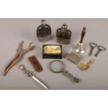 A box of collectables to include two leather and white metal hip flasks, magnifying glass, trinket