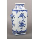 A Chinese blue and white kong vase. With moulded mask and loop handles and painted in underglaze