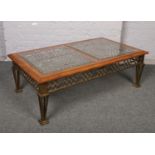 A modern glass top coffee table, with walnut surround and raised on a metal base, 130cm x 75cm, 44cm