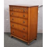 A carved oak chest of five drawers.