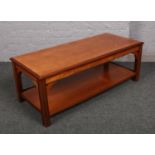 A teak two tier coffee table.