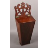 A Georgian Mahogany candle box with open fret work pediment.