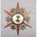 A vintage Bentima sunburst wall clock.