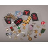 A collection of badges and medals, to include reproduction military examples, silver, HMS
