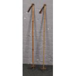 A pair of early 20th century Swiss bamboo and leather ski poles.