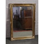 A Rectangular gilt framed bevel edged wall mirror, 60cm x 90cm.