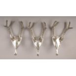 Three novelty chrome plate coat hooks. Each formed as a pair of antlers mounted on a shield.