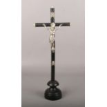 An early 20th century Continental ebonized alter cross with white metal figure and bone terminals,