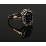 An Art Deco 9ct gold ring set with blue and white paste stones. Size P.