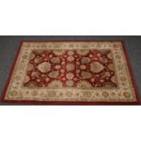 A Polypropylene red rug with floral design 120 cm x 170 cm