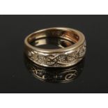 A 9ct gold Celtic scroll and diamond set ring. Gross weight 3.6 grams, size O.