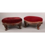 A pair of Victorian carved walnut oval footstools. With overstuffed velvet upholstery and raised