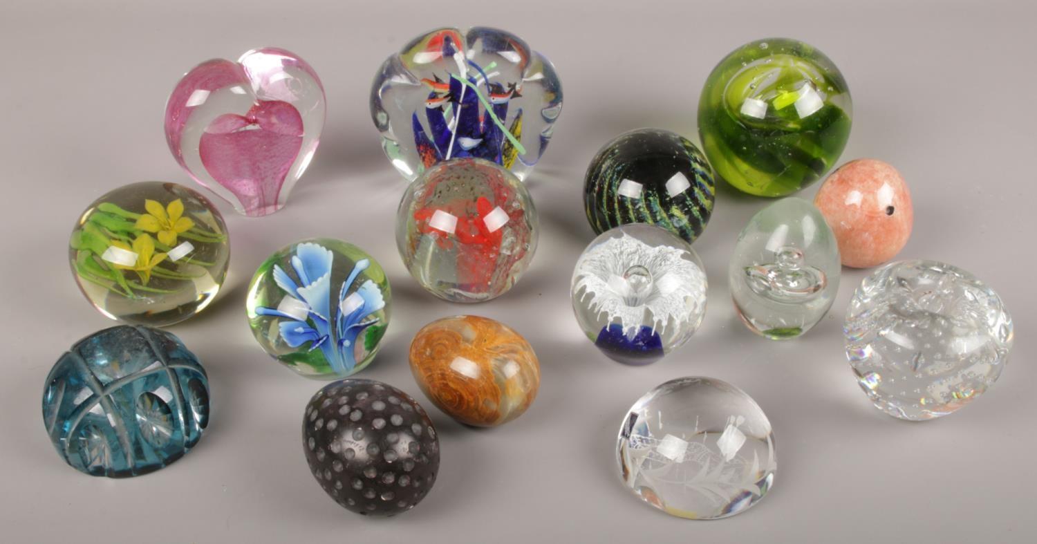 A collection of paperweights to include glass and onyx examples etc.