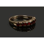 A 9ct gold seven stone garnet ring. Size P.