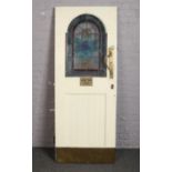 A pine public house door. With stained glass panel and Art Nouveau brass handles, 192.5cm x 75.