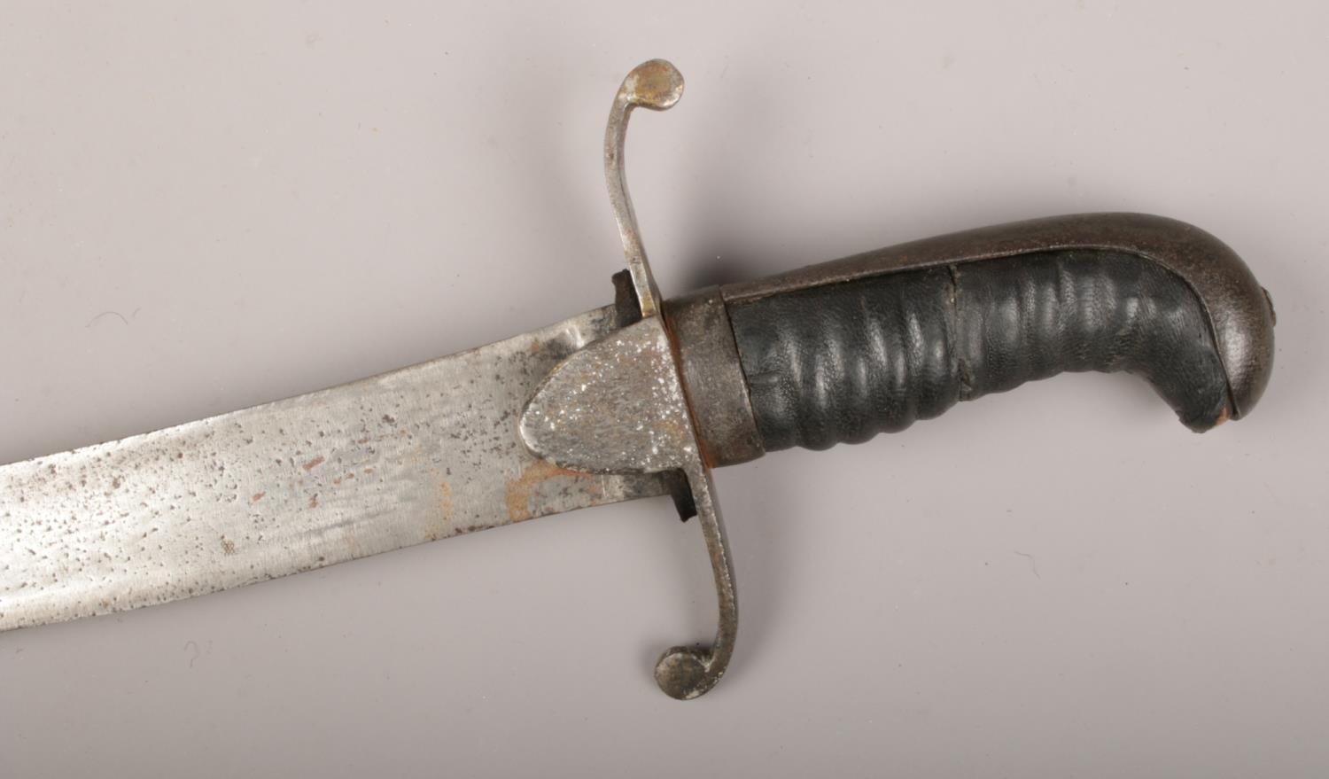 An early 19th century British sabre with scrolling cross guard and leather mounted grip. Blade 73cm. - Image 2 of 3