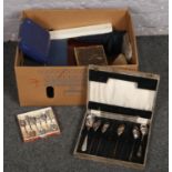 A box of cased flatwares to include collectors spoons, teaspoons, carving set etc.
