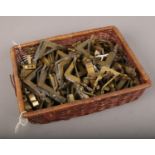 A basket of Victorian brass stair clips.