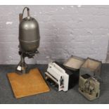 A Master II enlarger along with a Eumig mark S 807 D projector and another cased projector.