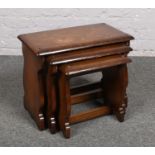 An oak nest of three occasional tables.