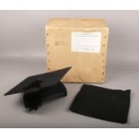 A boxed students mortar board by makers Ede & Ravenscroft size 6 7/8 and a similar professors cap,