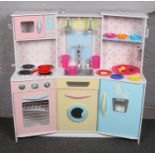 A retro style childs large play kitchen and accessorizes, 110cm x 112cm.