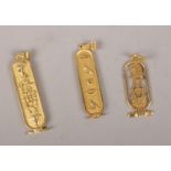 Three 9 ct gold pendants with Egyptian design.