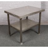 A stainless steel two tier preparation table.