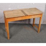 A vintage double school desk incorporating inkwells, 102cm wide.